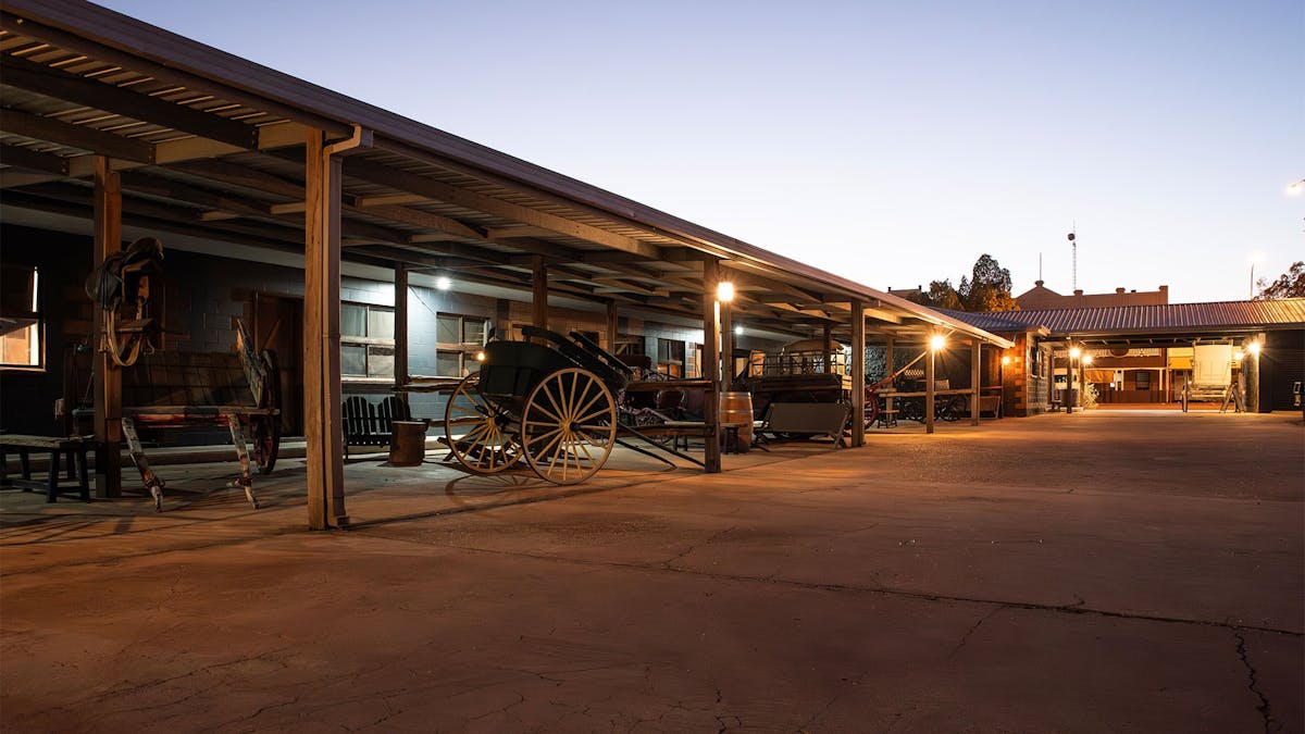 The Stables Courtyard at night with vintage vehicles