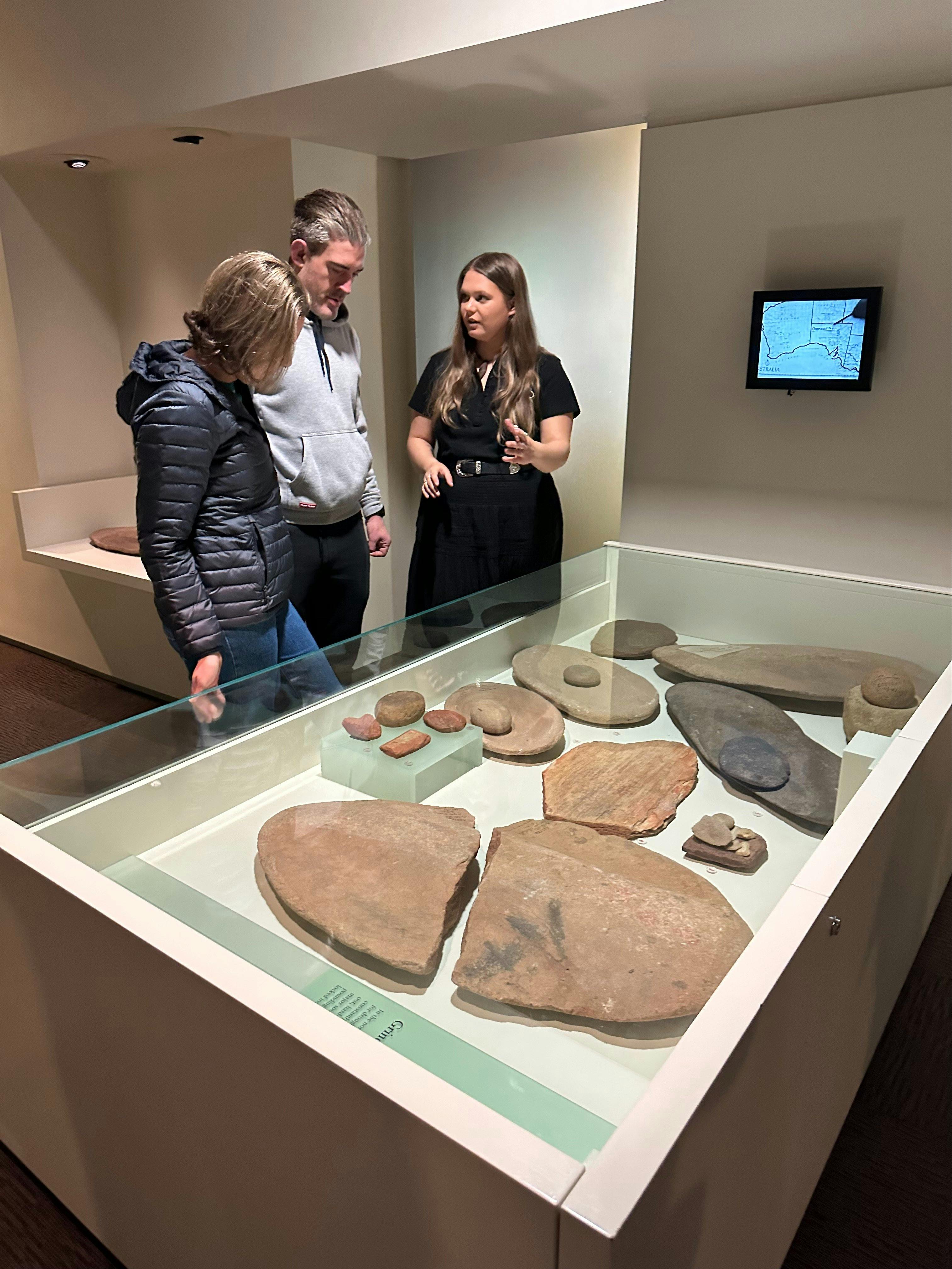 Bookabee Guide Iteka, explaining the use of grinding stones. at the Aboriginal Cultures Gallery SAM