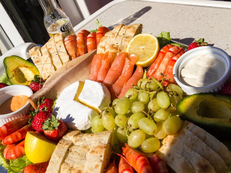 Seafood platter inluding prawns, fresh fruit, cheese and turkish bread