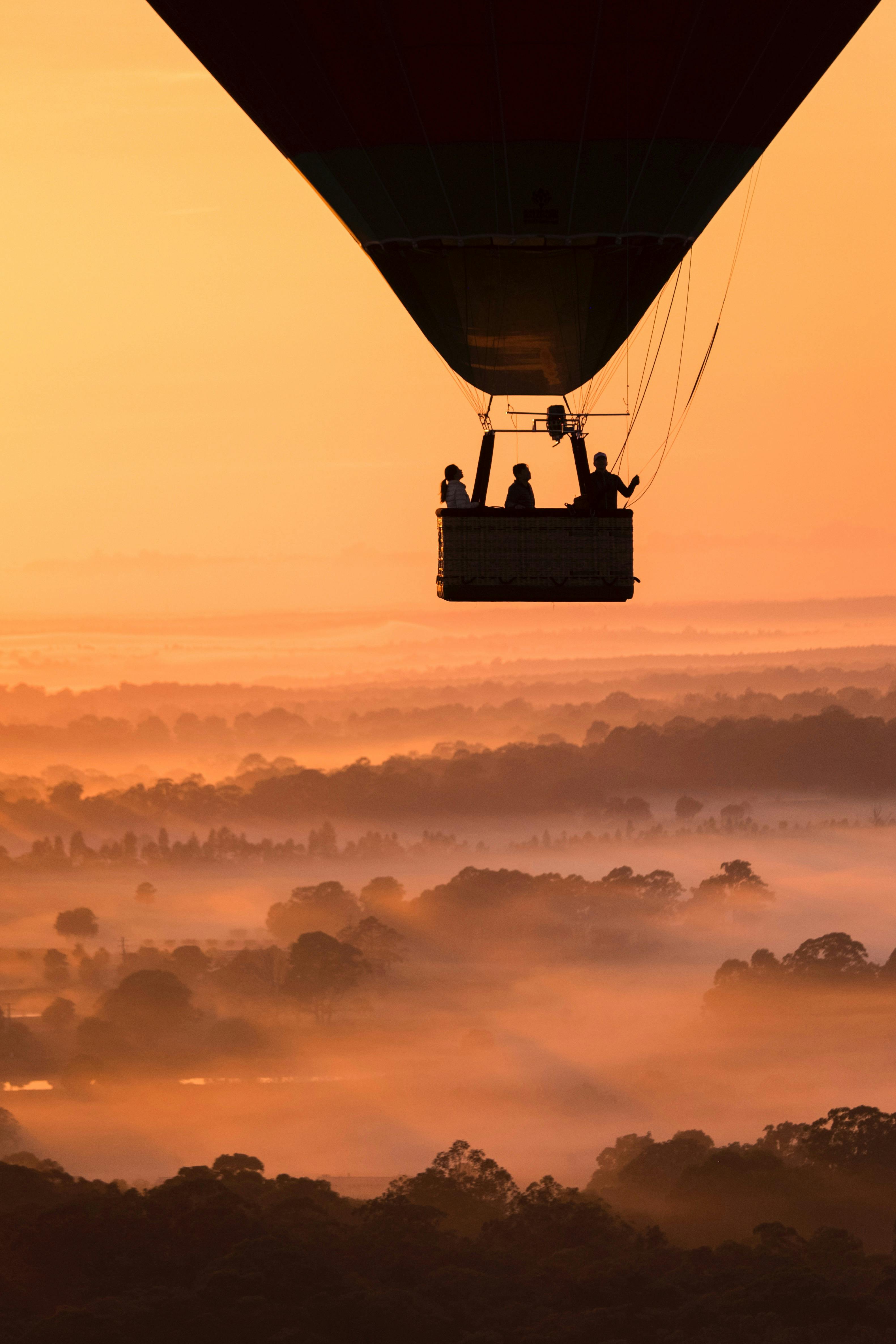 Balloon flight passengers watching the sunrise