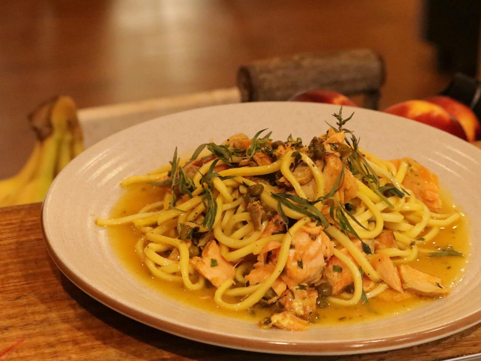 A plate of hand cut spaghetti with smoked trout, saffron, capers and tarragon