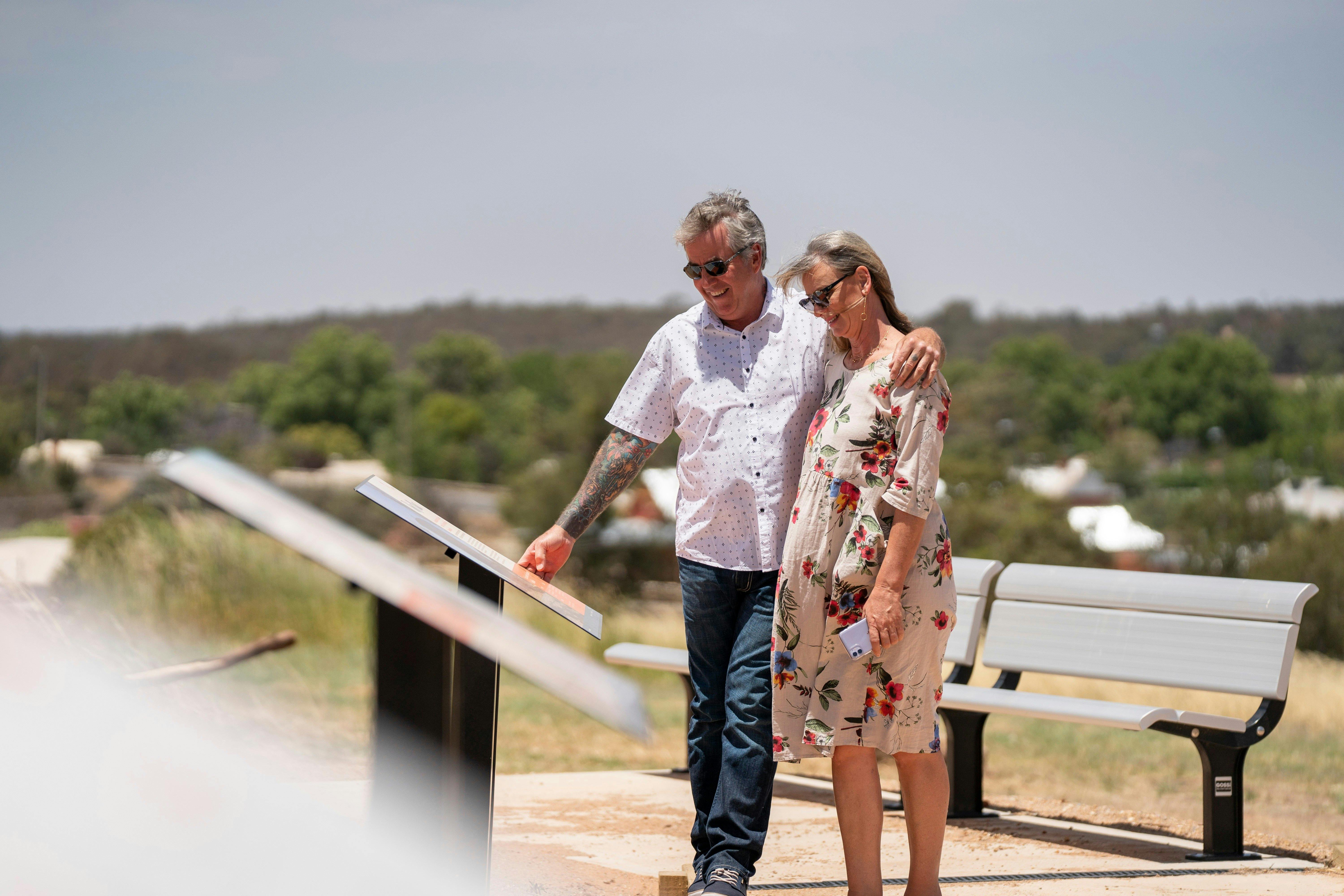 A couple walking the Narrandera Water Tower Art Trail