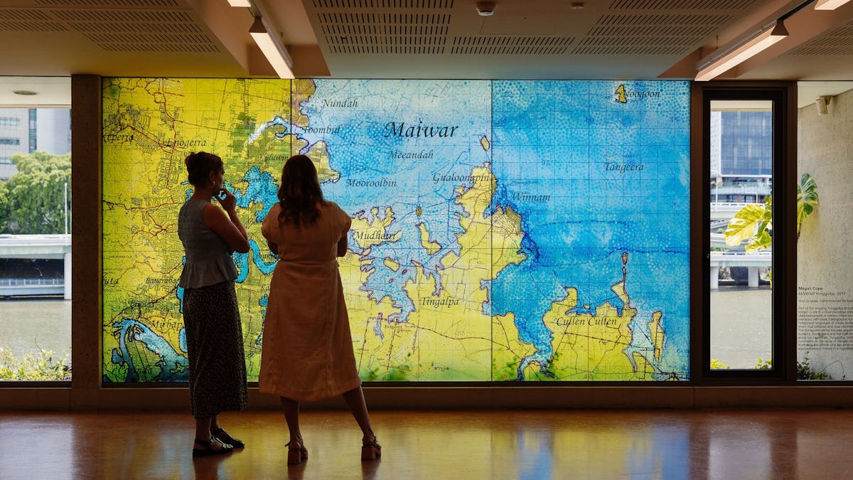 Two women looking at an indigenous map