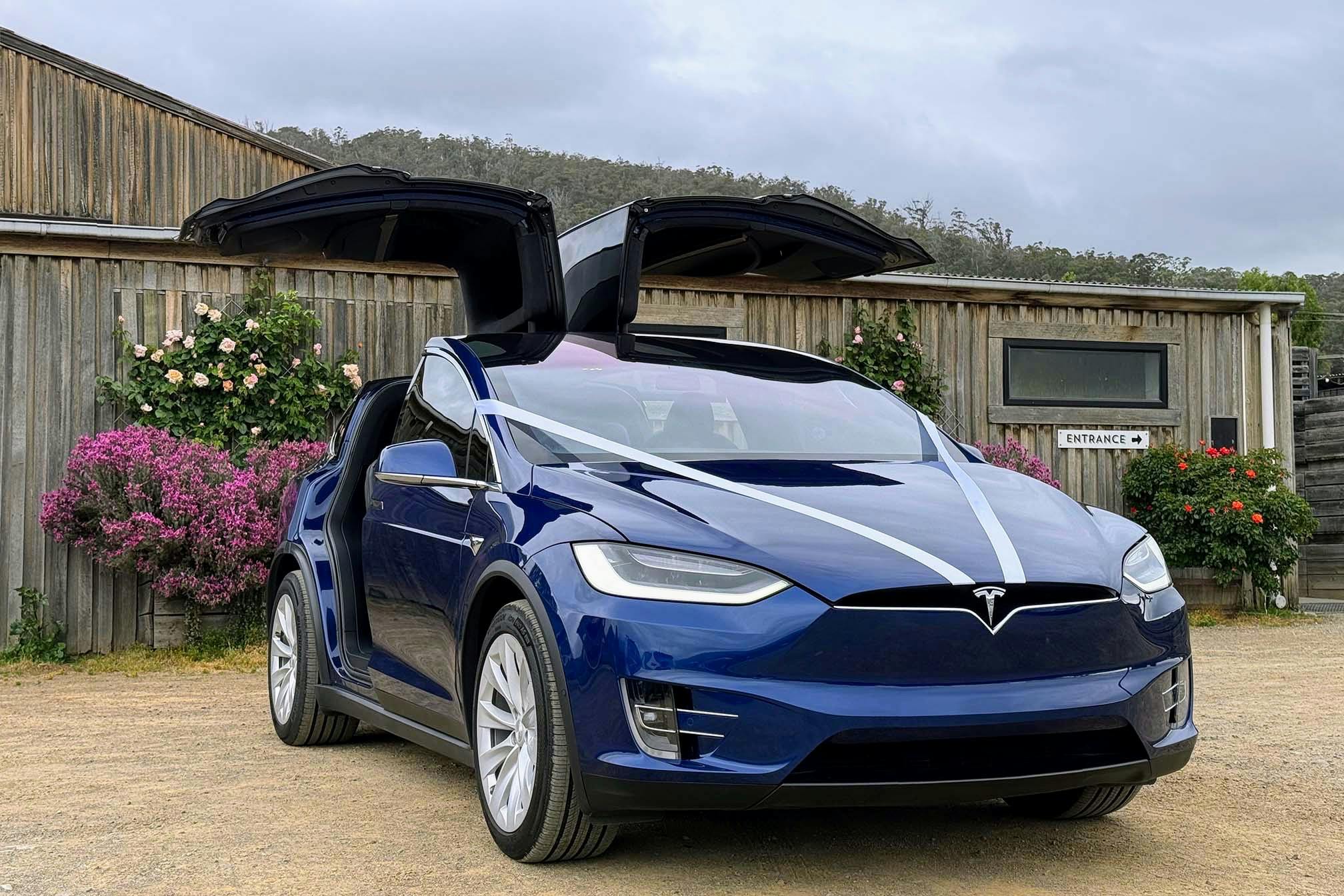 EVRide Tesla Model X as a wedding vehicle at Willie Smiths Apple Shed with falcon-wing doors open