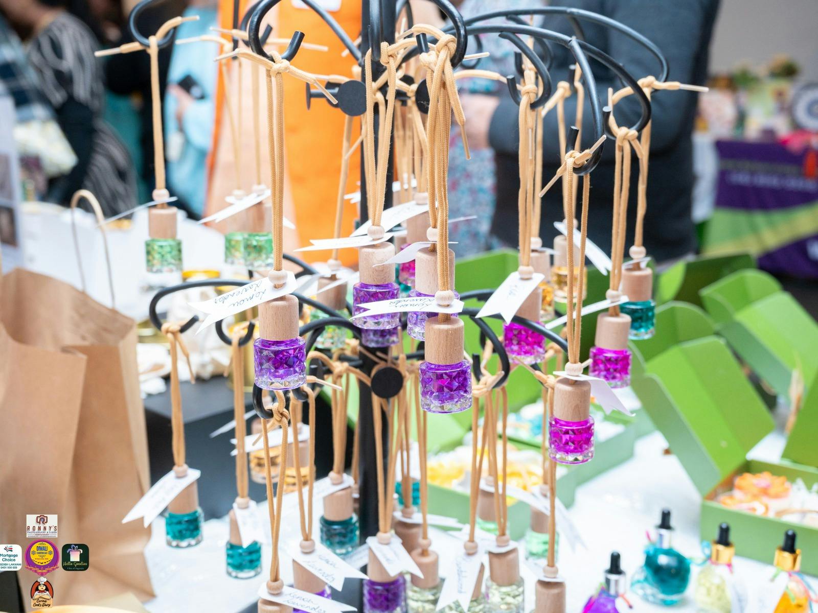 Close-up of handmade car scents and candles displayed at a stall
