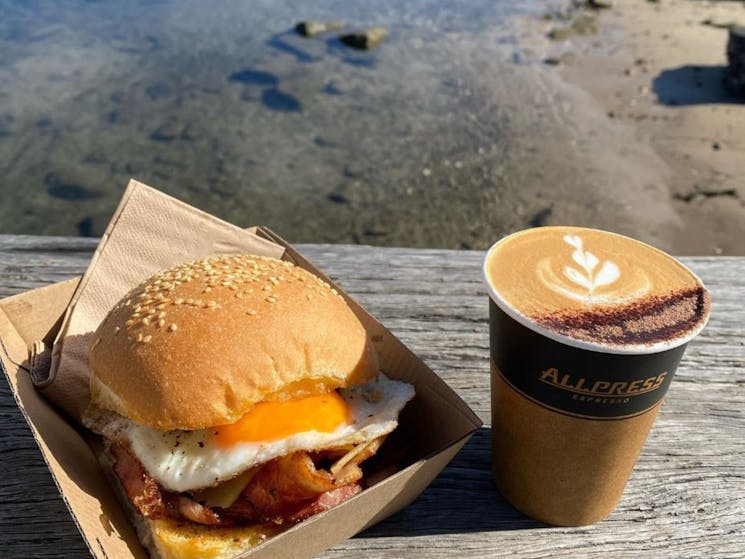 egg and bacon roll with coffee