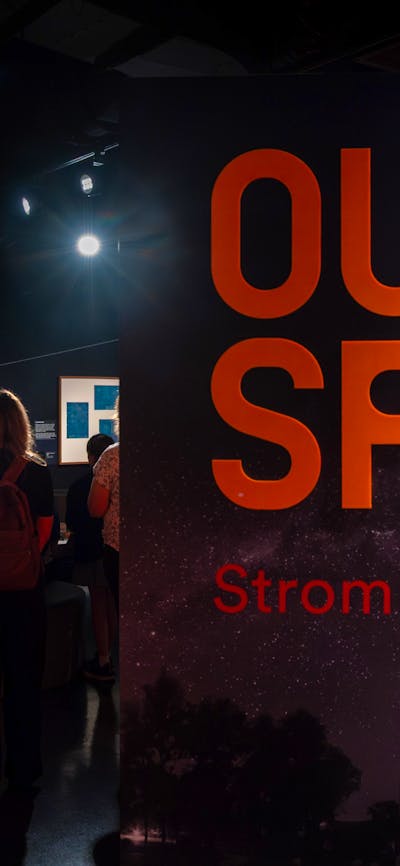 A group of people learning about the history of Mount Stromlo Observ