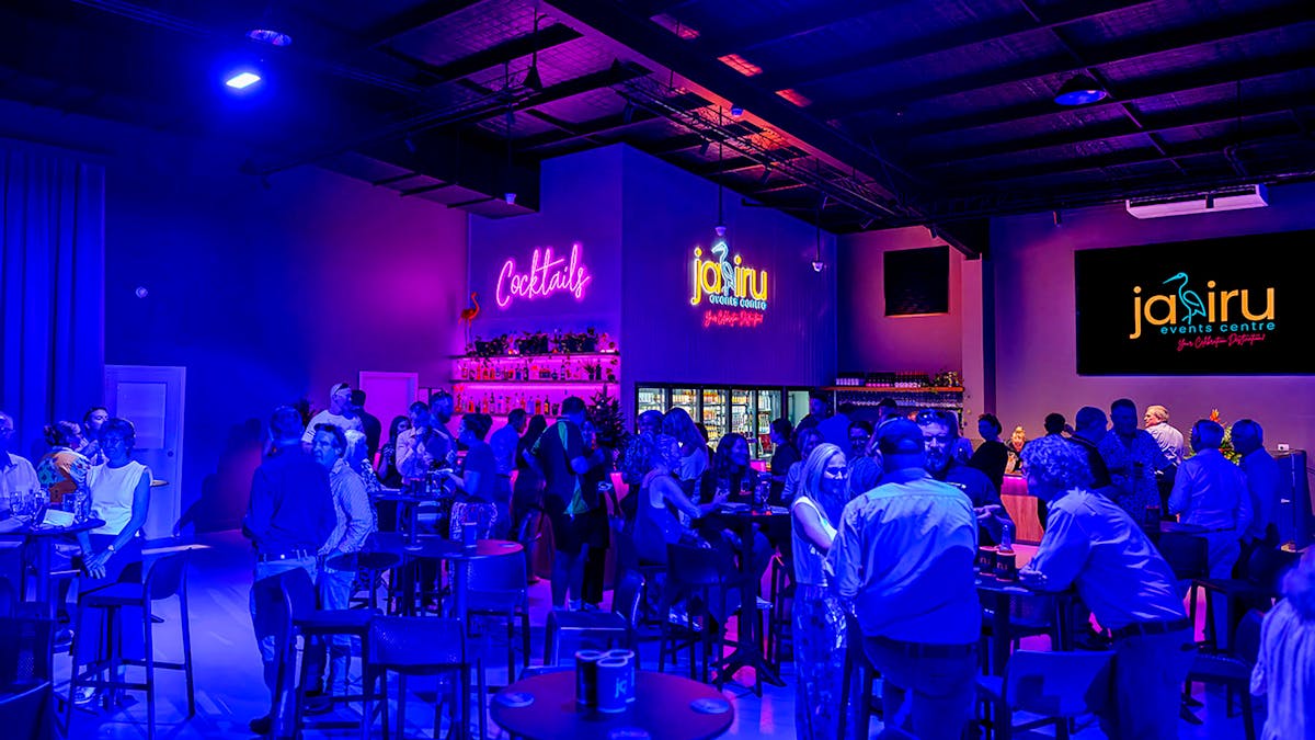 Guests standing and sitting on stools around the Jabiru Events Centre bar.