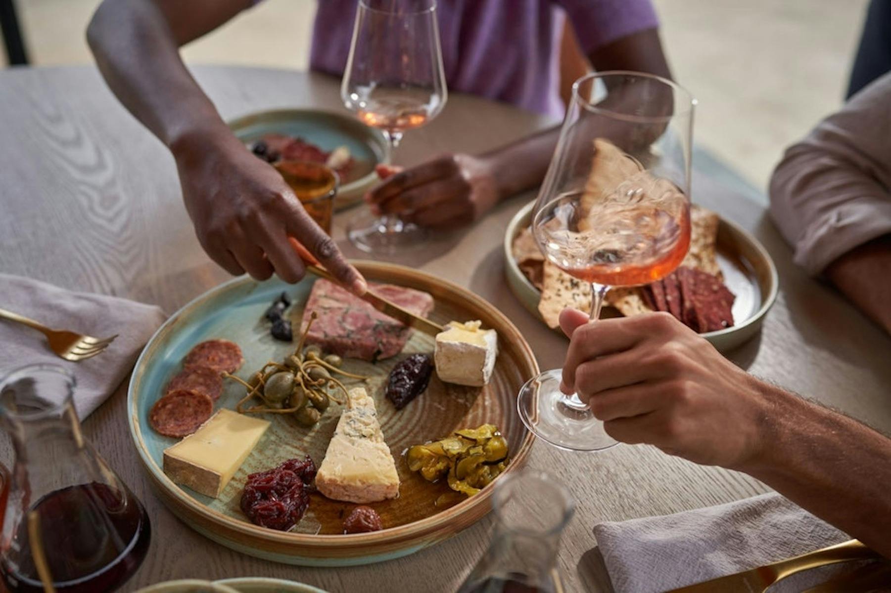 2 people share a grazing board and wine