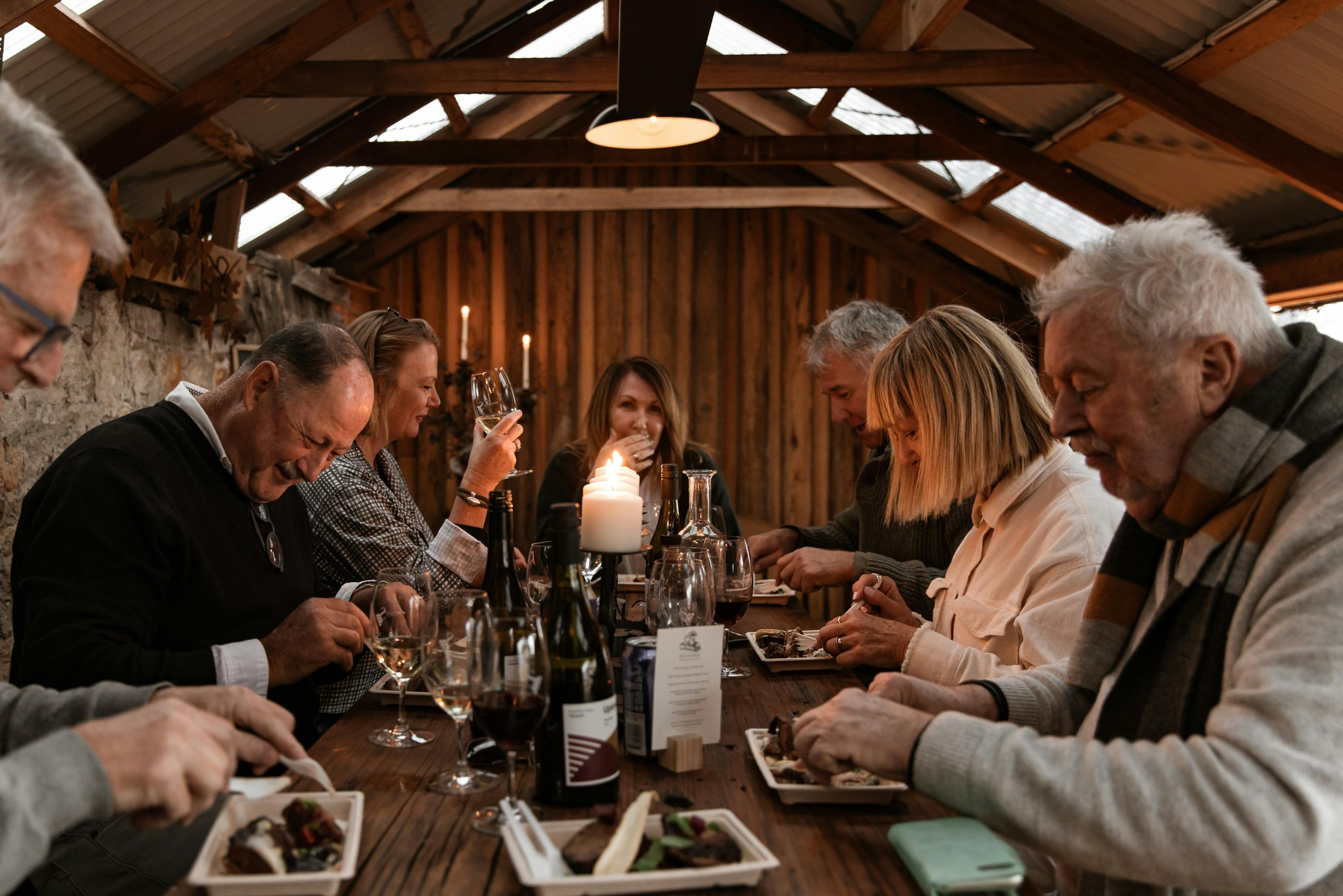 people in shed dining in candle light