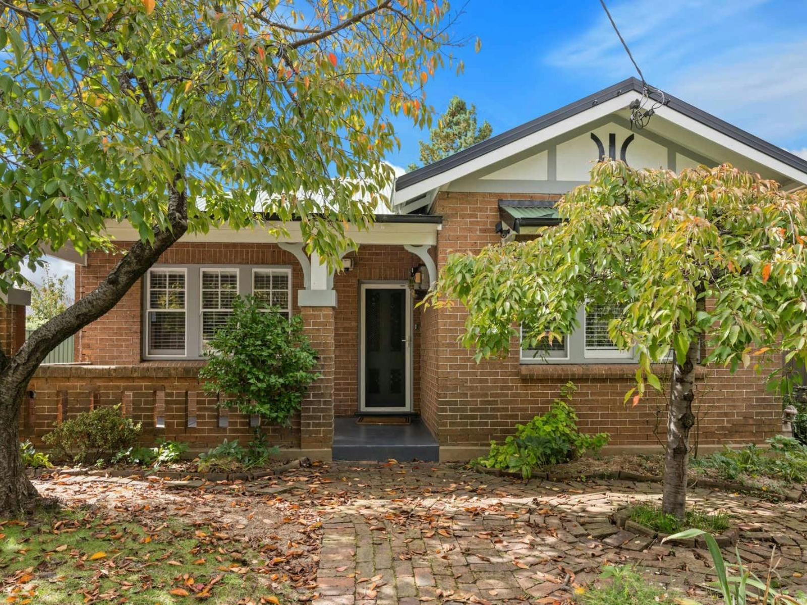 Heritage brick home with lots of greenery