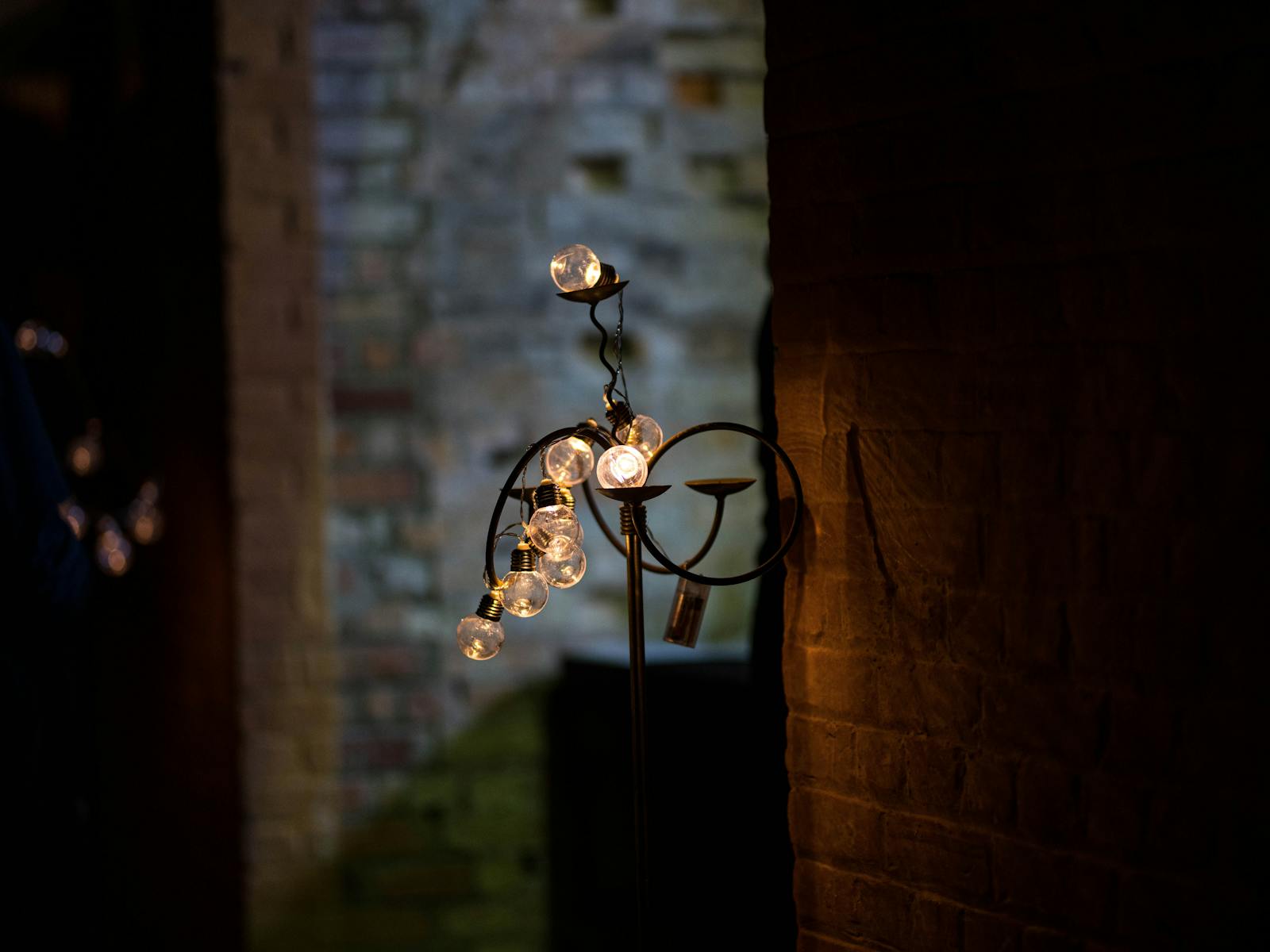 A 19th century style lamp hanging on the sandstone wall