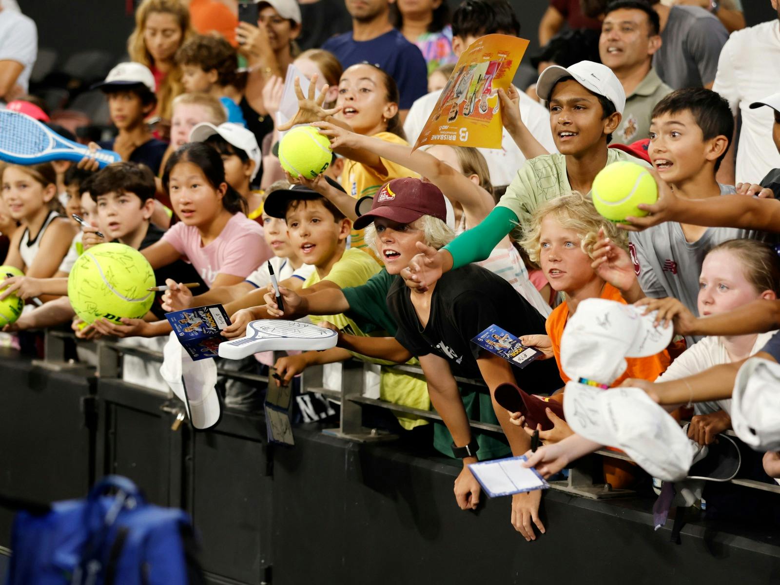 Kids waiting for player autographs court side.