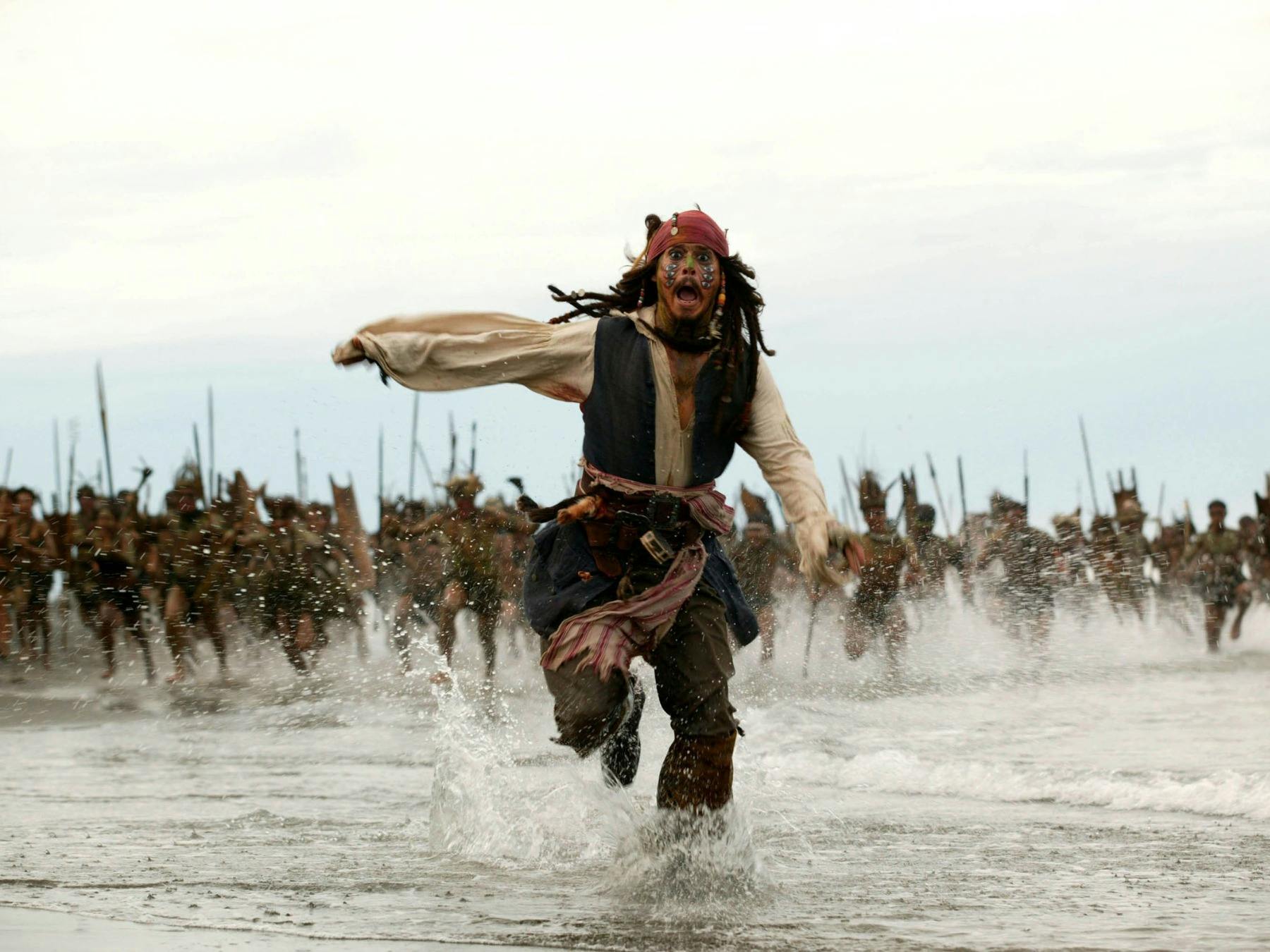 Pirate running through shallow water being chased