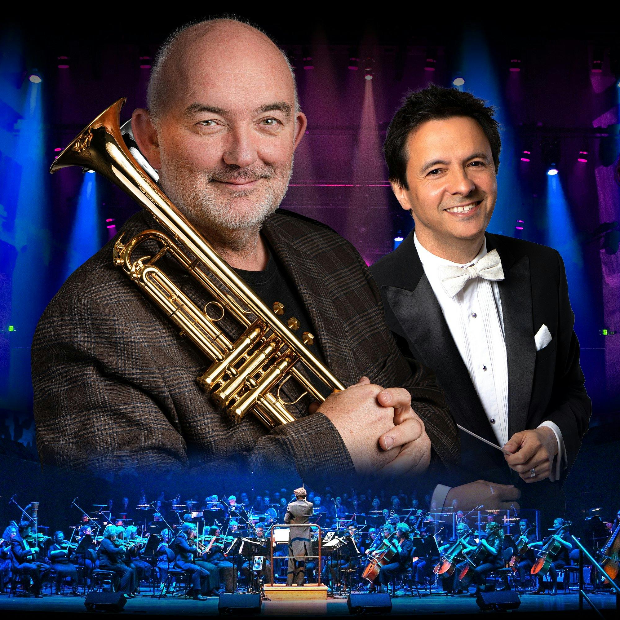Two men in suits in front of a blue and purple background. One of the men is holding a trumpet.