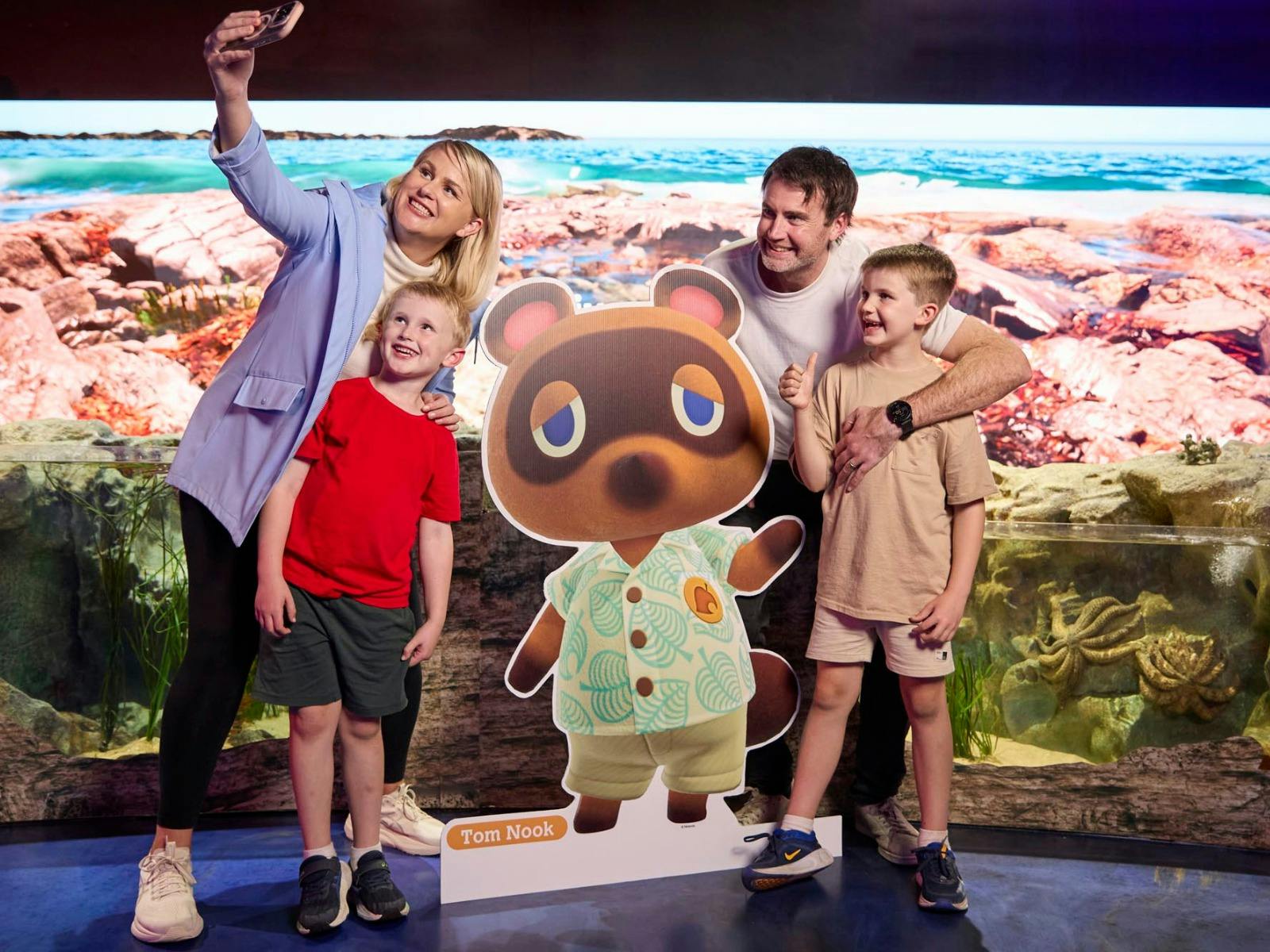 Family enjoying Animal Crossing: New Horizons at SEA LIFE Sydney Aquarium