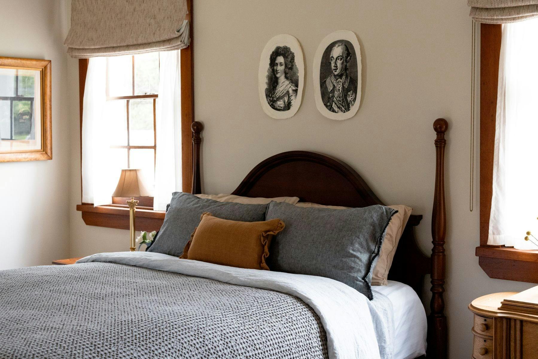 Queen bed in large room with attached private bathroom