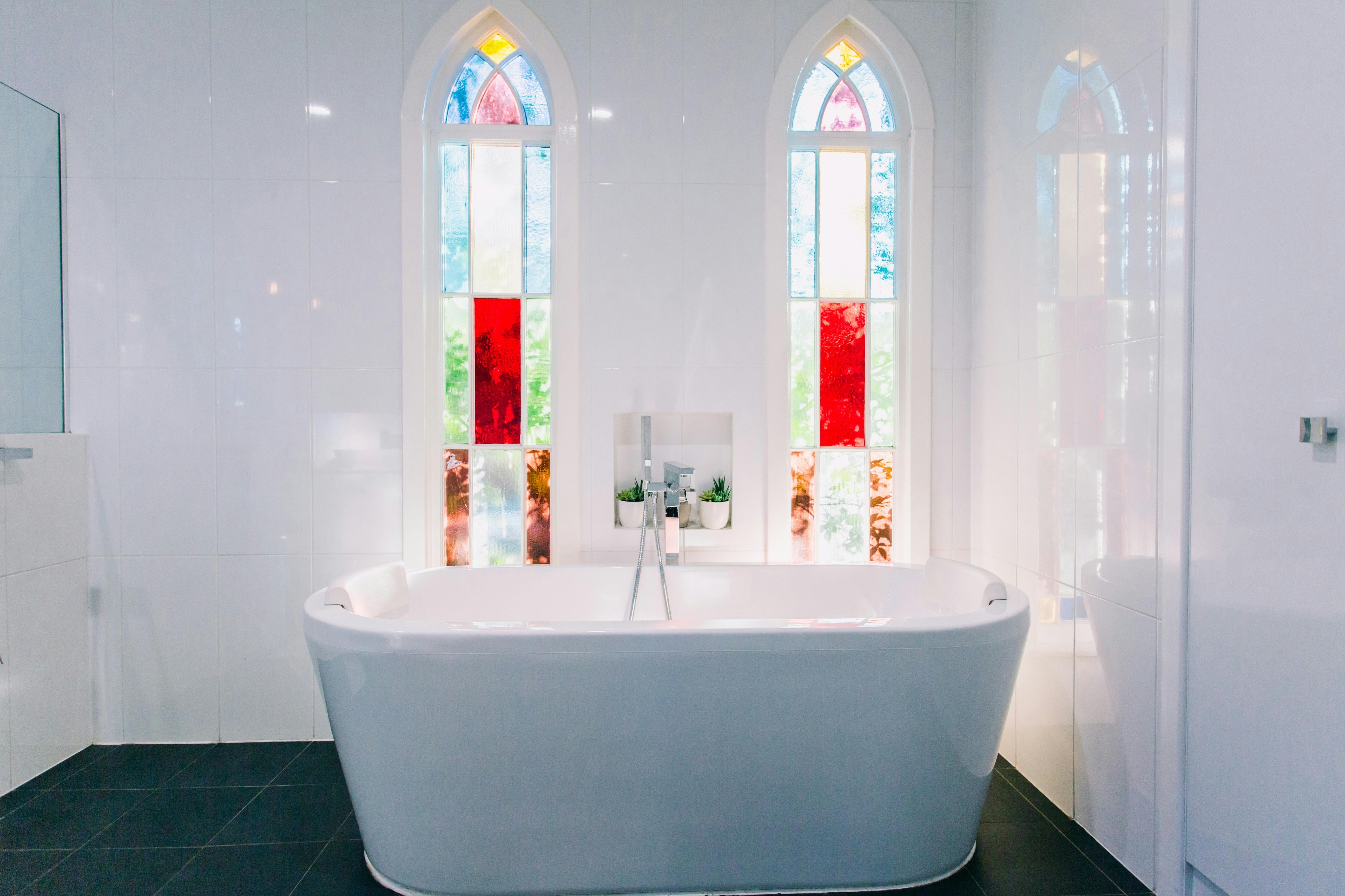 2 person bath with original 1882 stained glass windows at Bellingen Converted Church