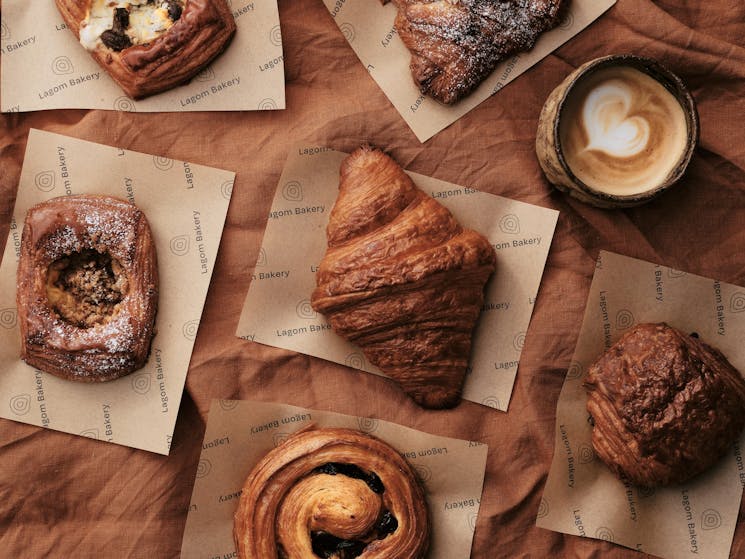 lagom bakery pastries including croissant, sweet danish, almond croissant and coffee