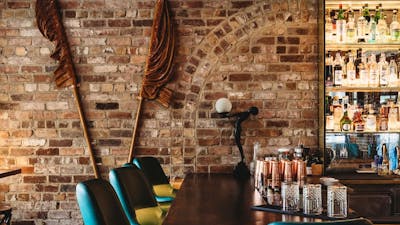 Bar stools and brown flags decorating back wall