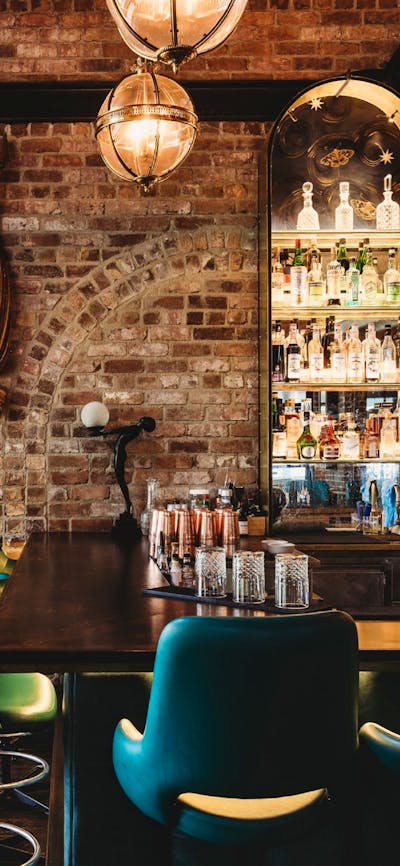 Bar stools and brown flags decorating back wall