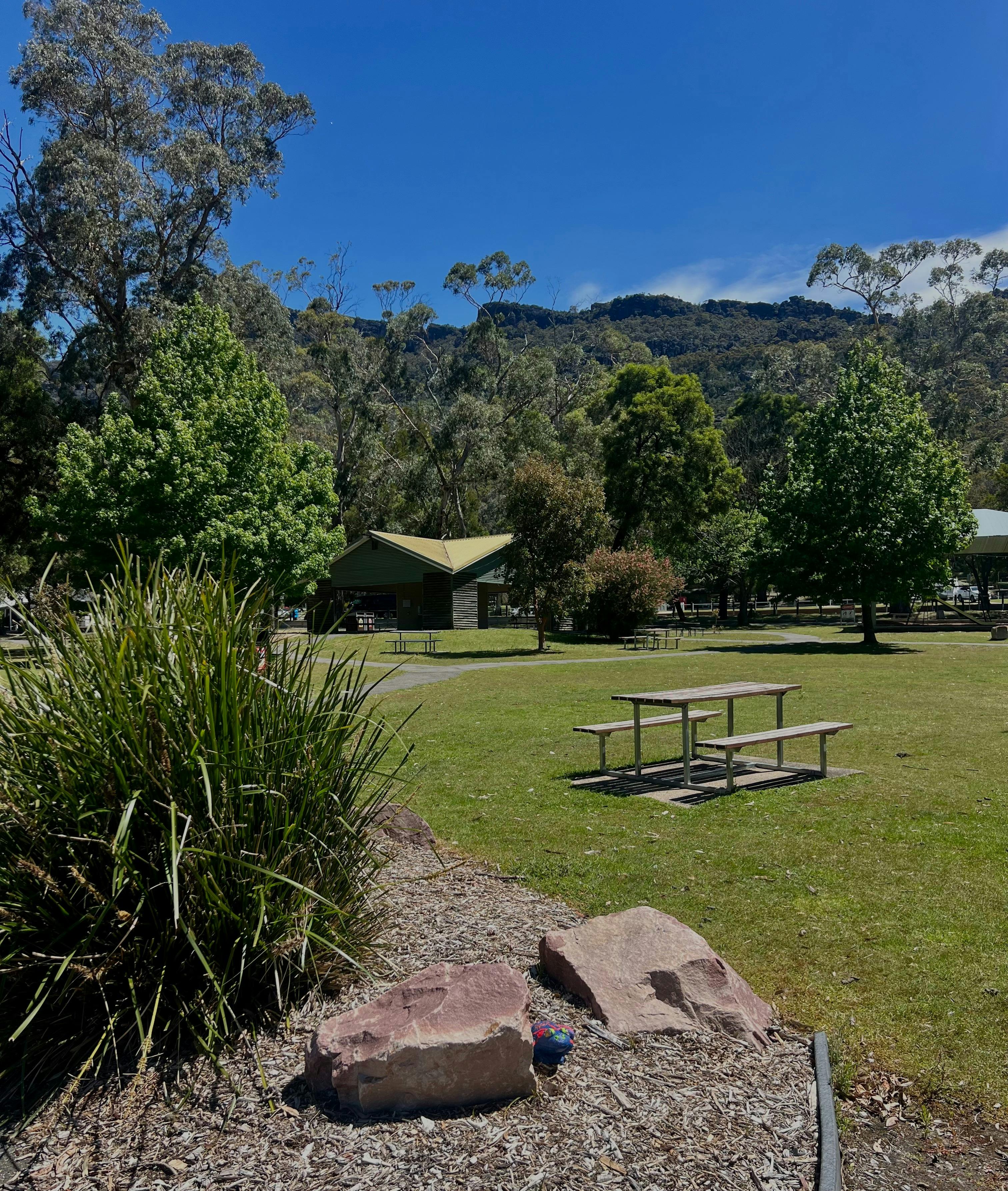 A picnic table and chairs in a park area