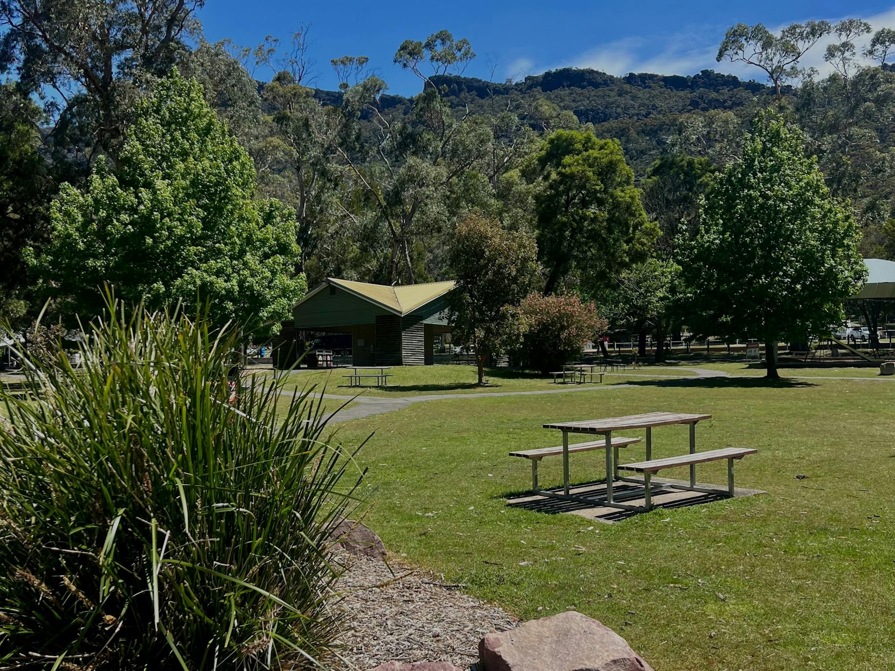 A picnic table and chairs in a park area