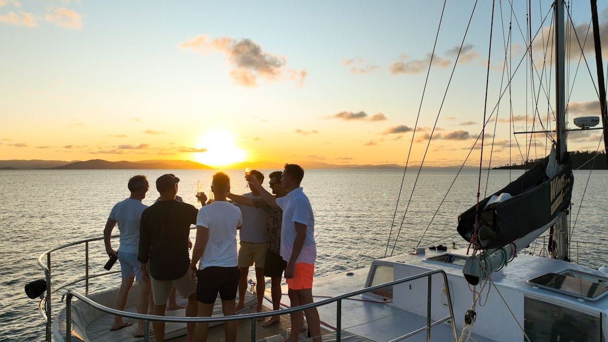 Group cheers at sunset on the sundeck
