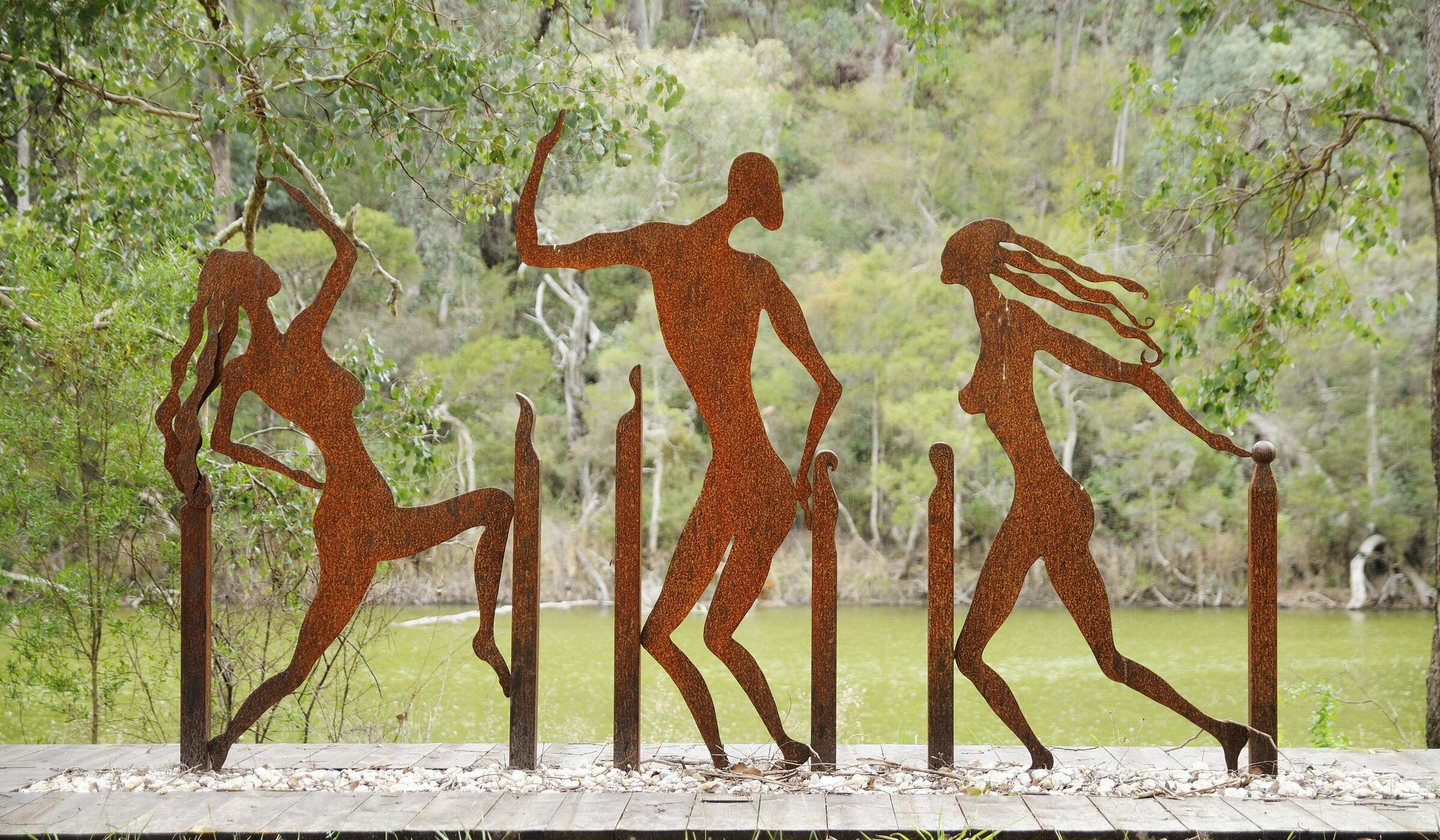 Metal sculptures shaped as people dancing