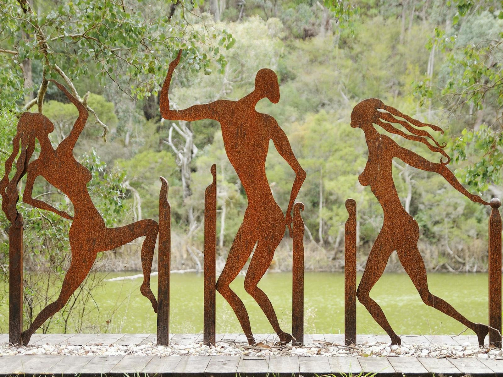 Metal sculptures shaped as people dancing
