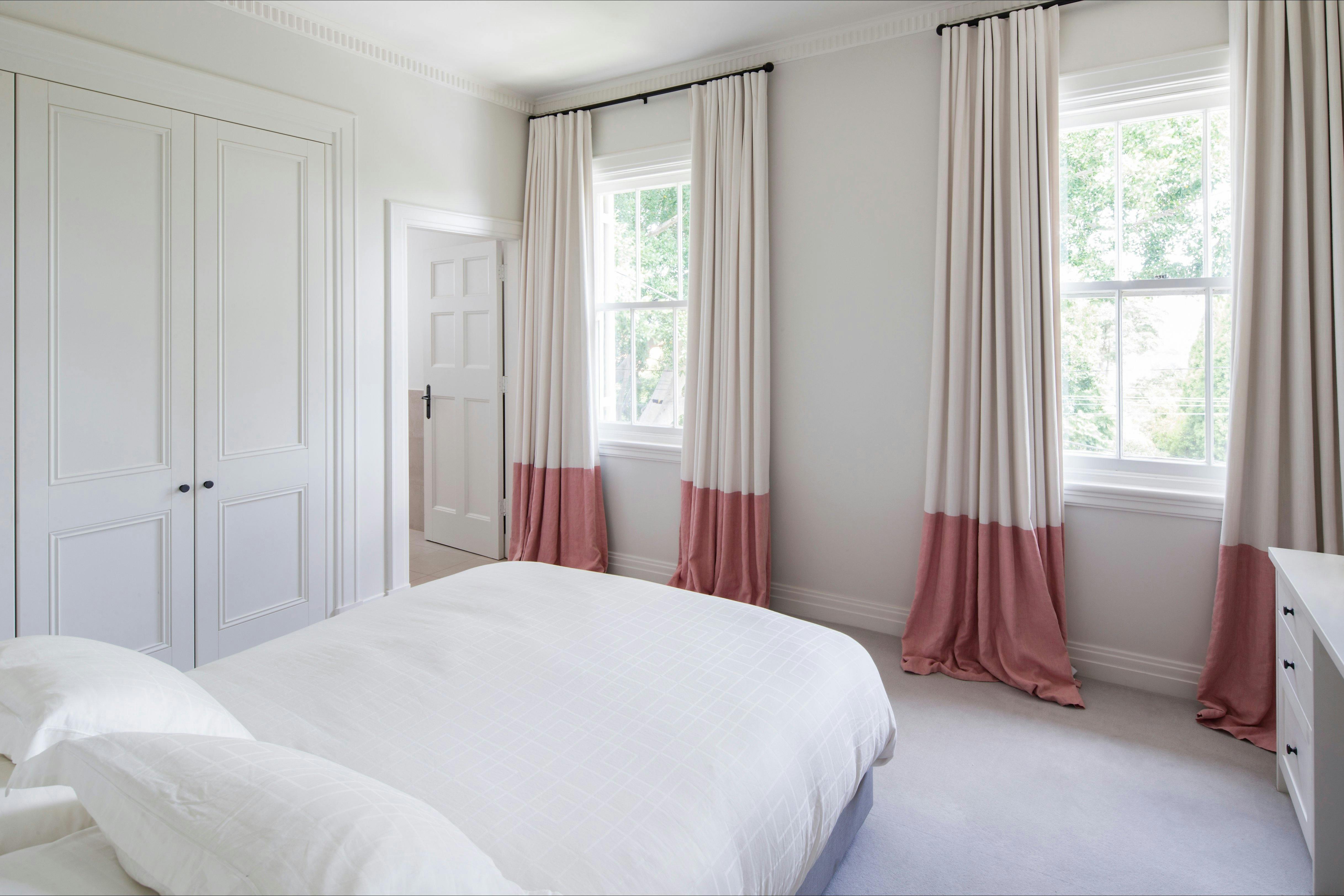 Bedroom with queen bed and large cupboards