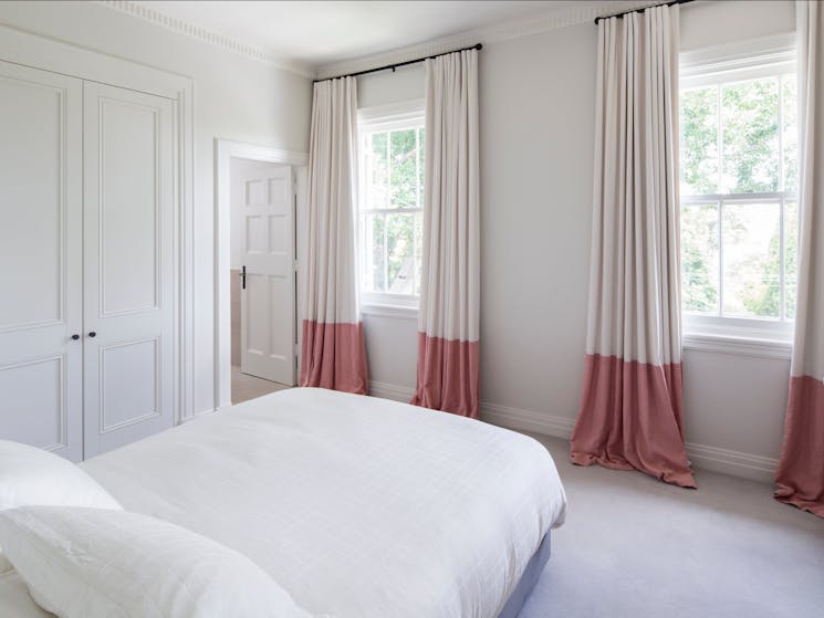 Bedroom with queen bed and large cupboards