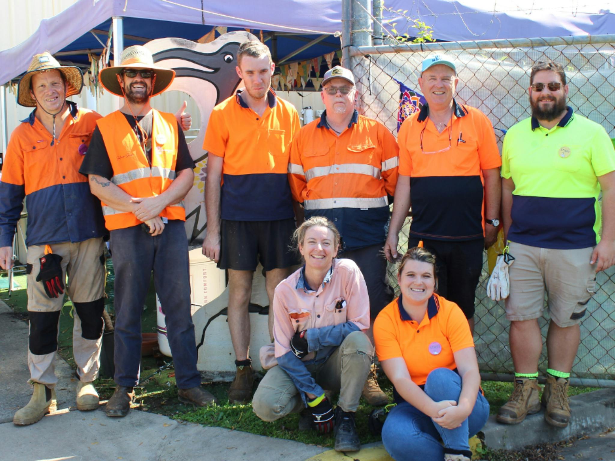 Image of eight staff members who work at the Salvage Shed