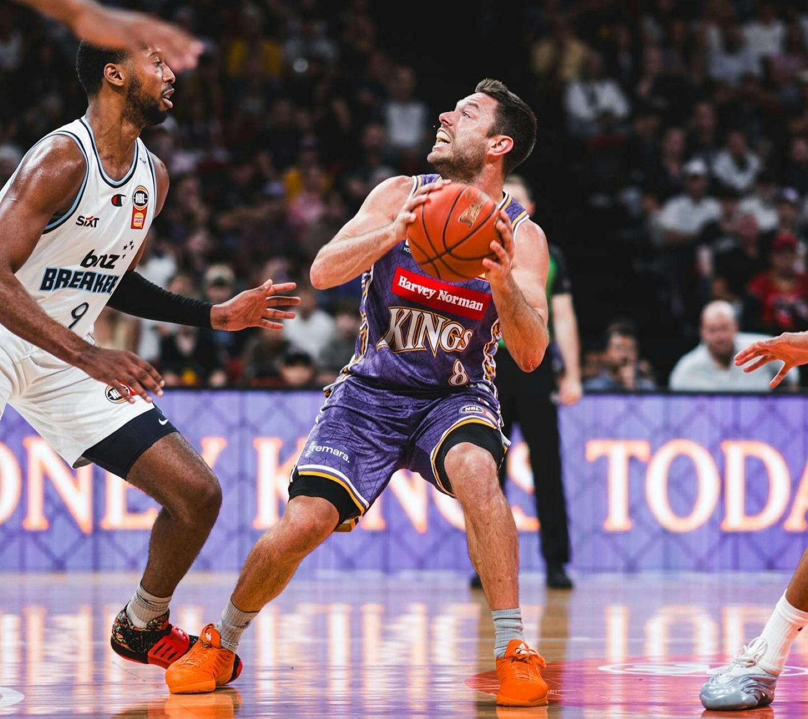 Sydney Kings player and opponent on court