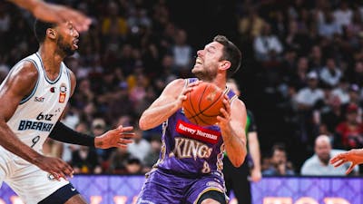 Sydney Kings player and opponent on court