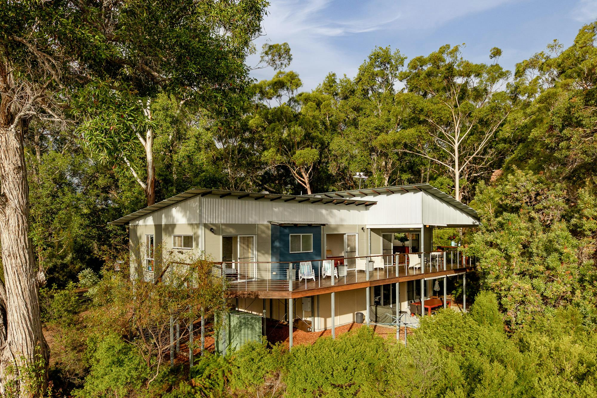 Expansive 18m entertaining deck with outdoor dining and seating, spectacular sunset and water views