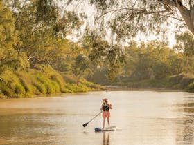A woman paddles peacefully on the beautiful Cooper Creek