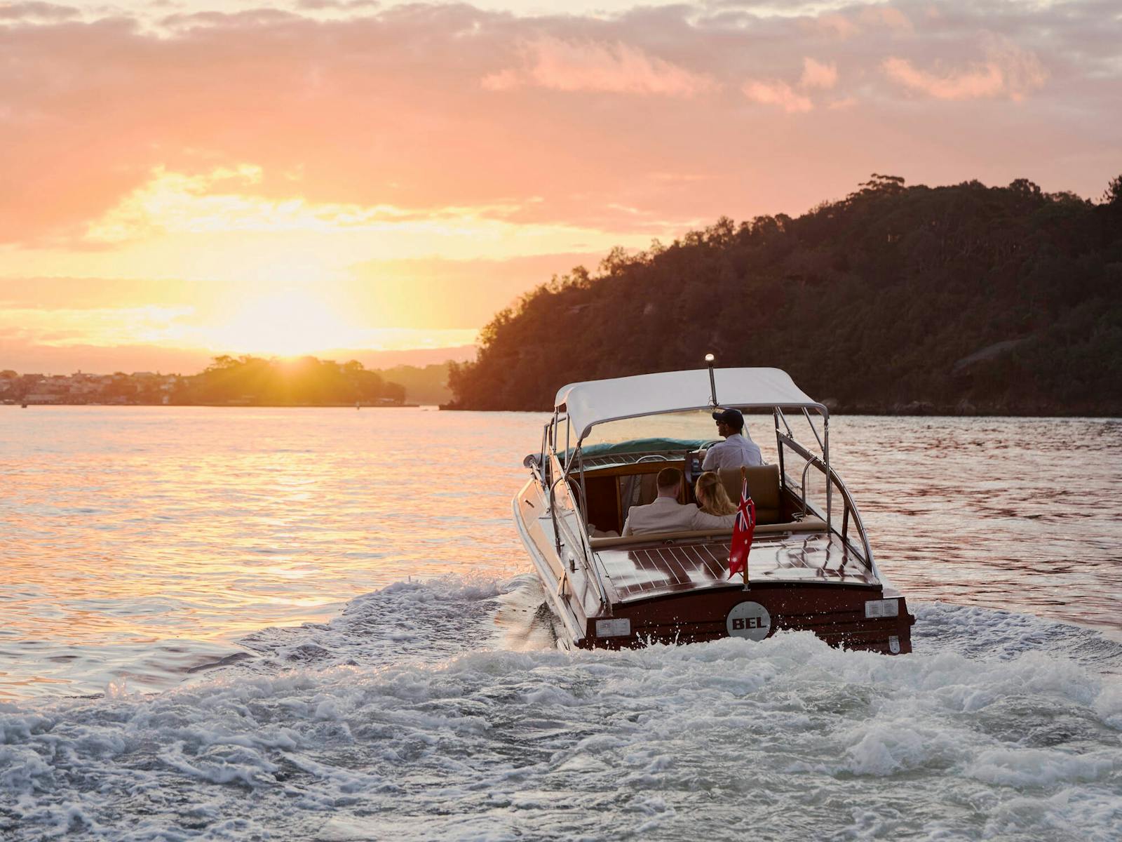 MV BEL private cruise on Sydney Harbour with Sydney city skyline and Harbour Bridge.