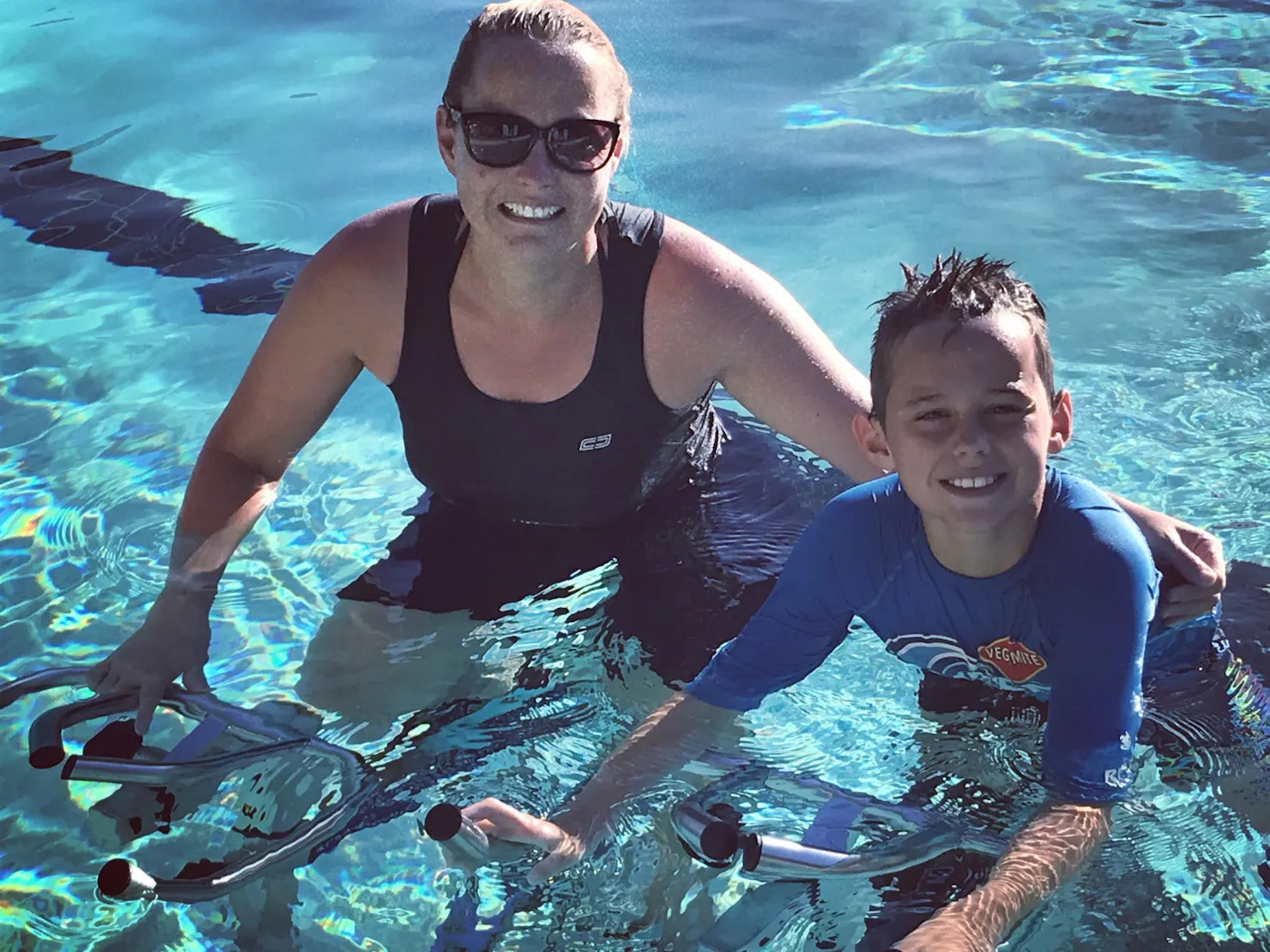 mother and child cycling underwater