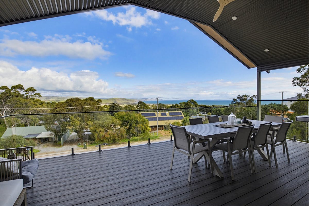 Outdoor dining on the balcony with ocean views at Panorama Lookout Normanville