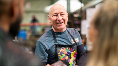 Smiling face of producer Wagonga Coffee at farmers market in Canberra