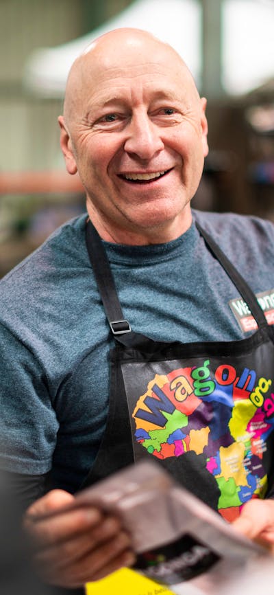 Smiling face of producer Wagonga Coffee at farmers market in Canberra