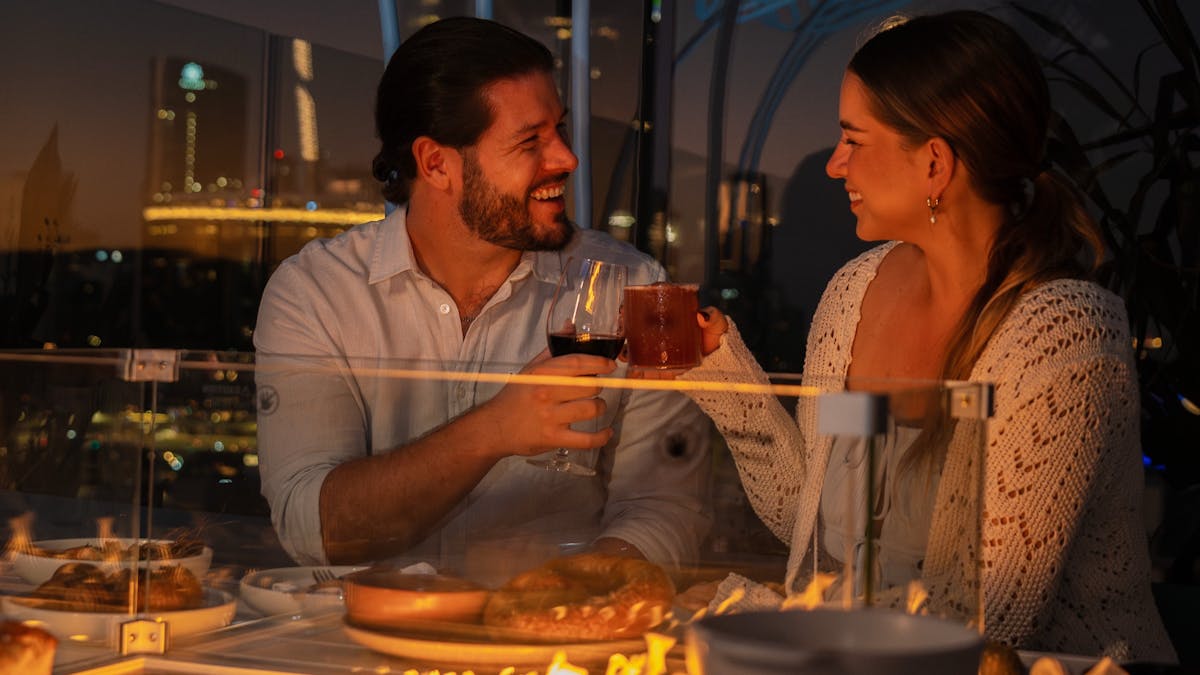 Fire pit overlooking the brisbane city, a couple enjoying the banquet