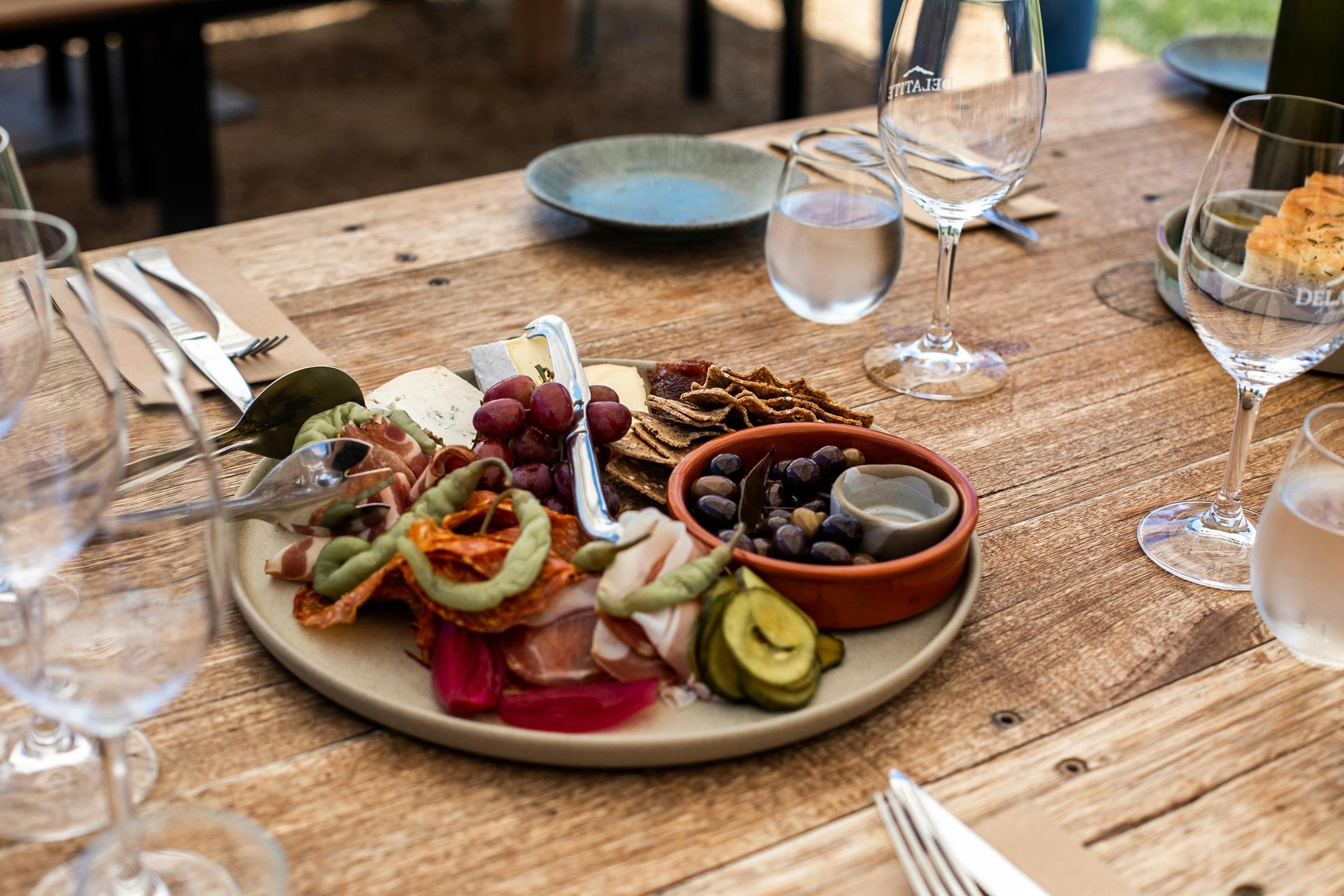 a table set with an antipasto platter in the middle