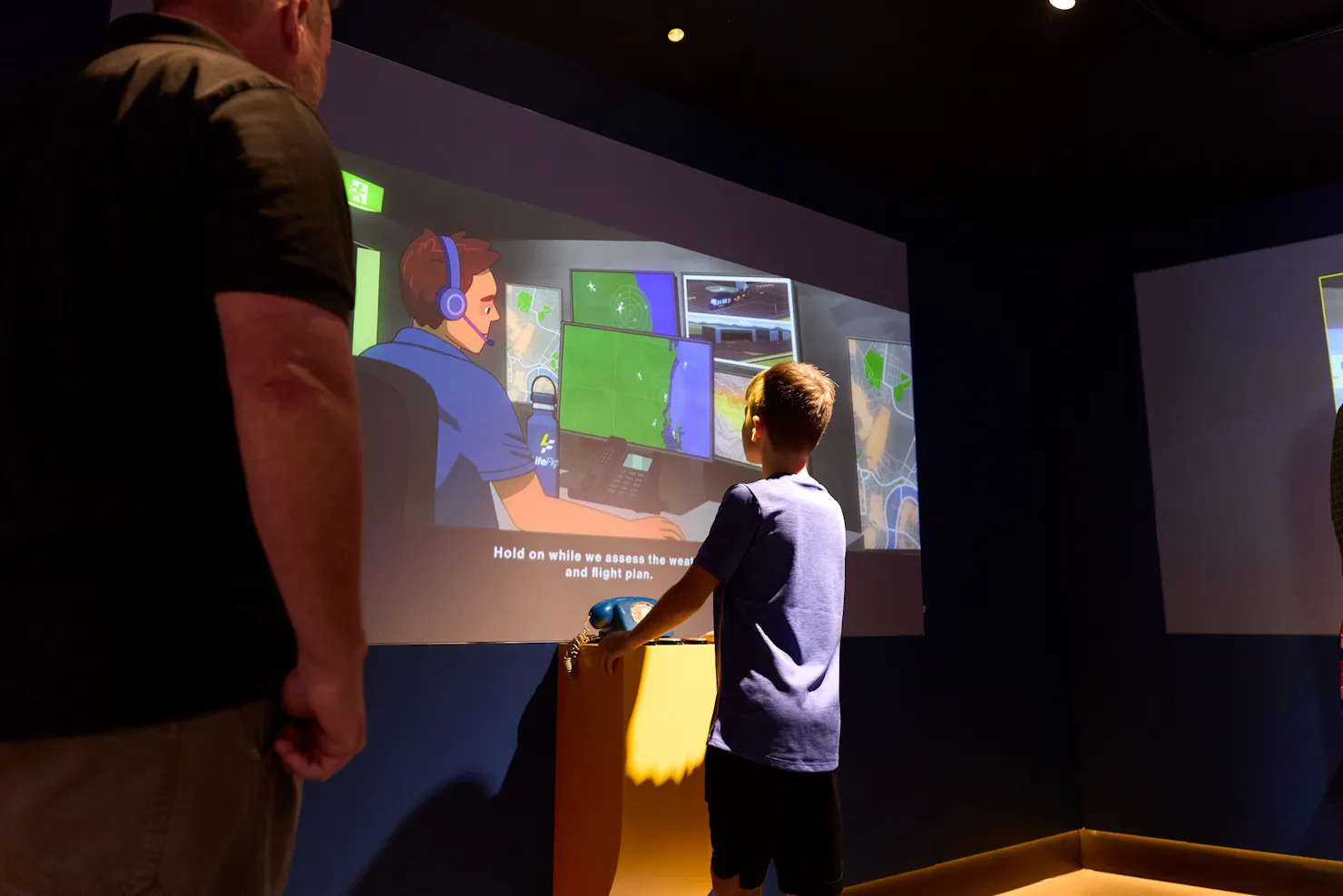 Child with Dad engaging with interactive display