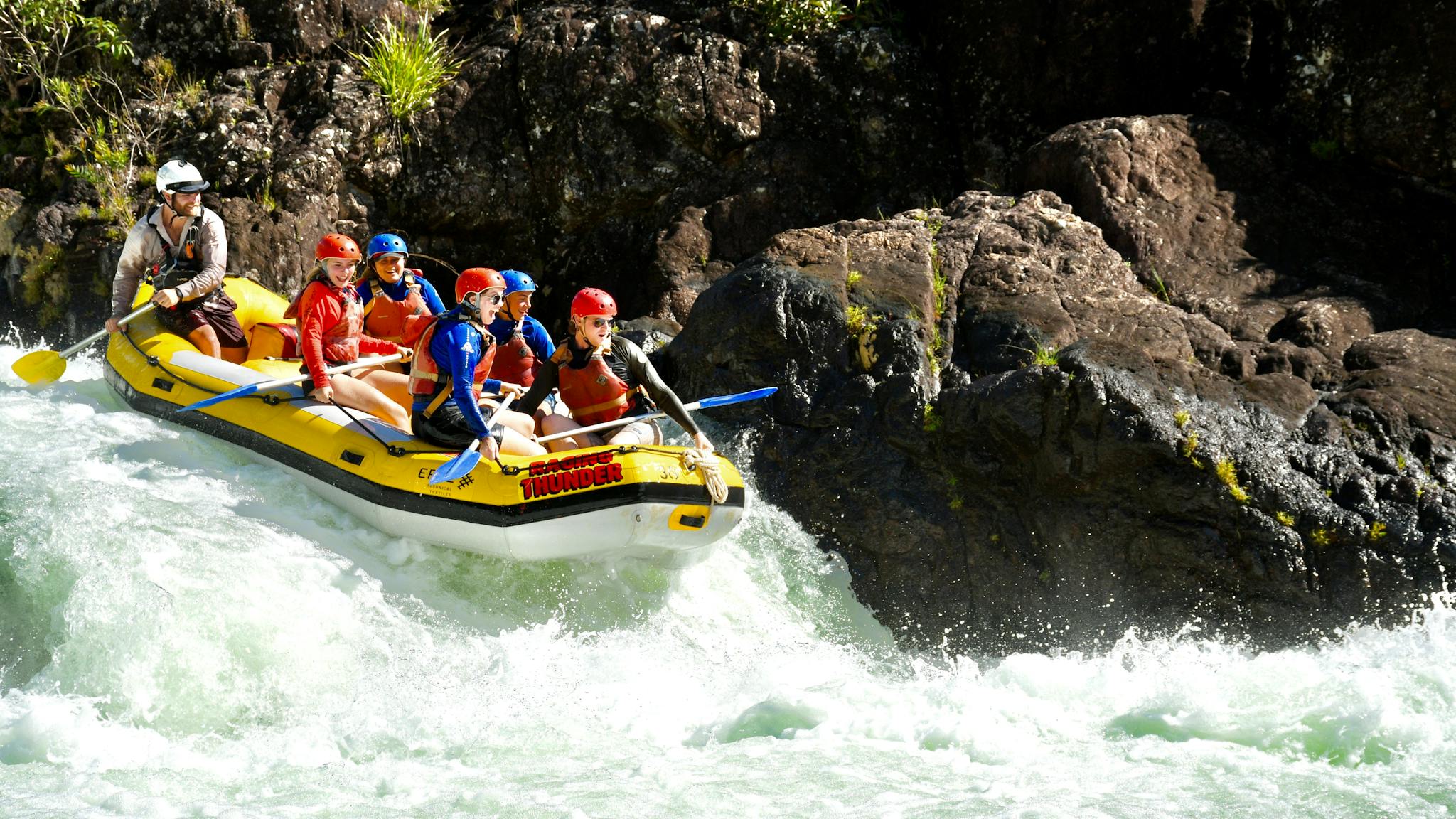 Group of Rafters approaching a rapid on the Tully Gorge National Park River on Cassowary Coast Group of Rafters approaching a rapid on the Tully Gorge National Park River on Cassowary Coast