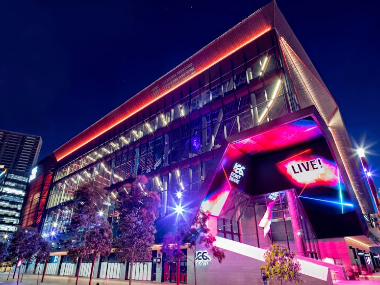 The ICC Sydney Theatre, a vibrant live music venue, illuminated under the night sky.