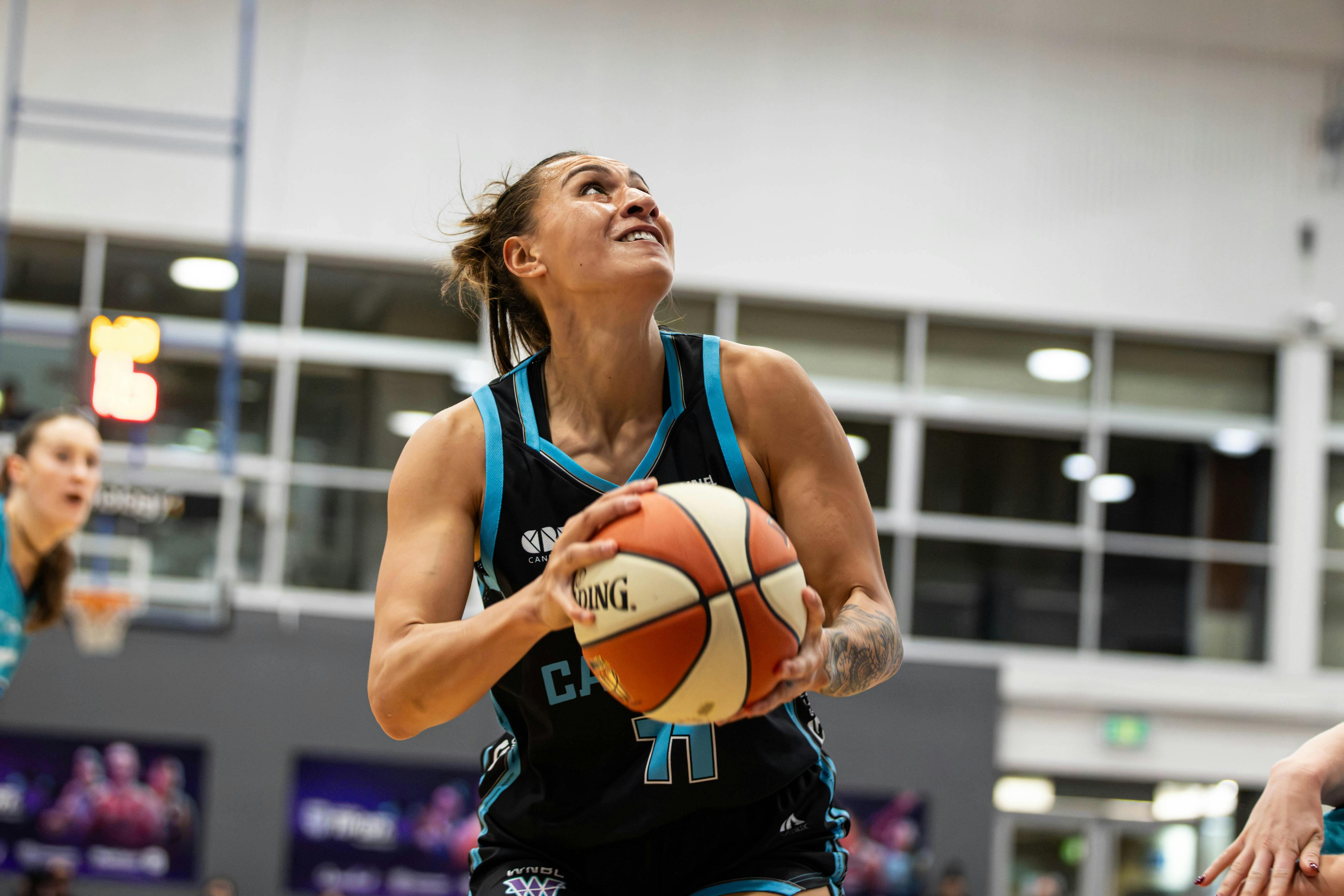 Basketball player goes up for a shot attempt.