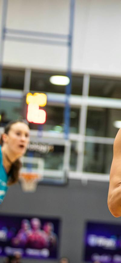 Basketball player goes up for a shot attempt.