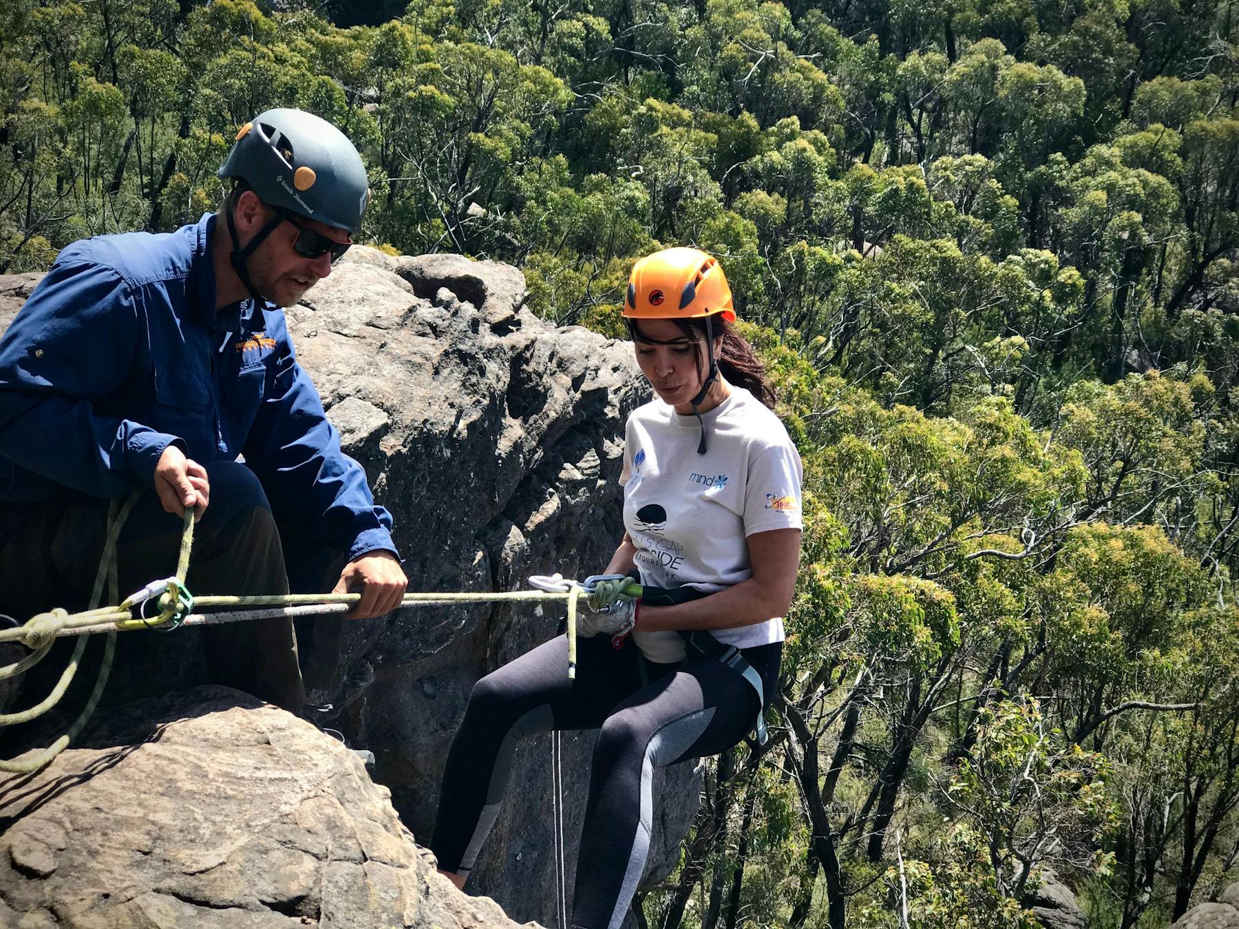 Qualified and experienced guides abseiling